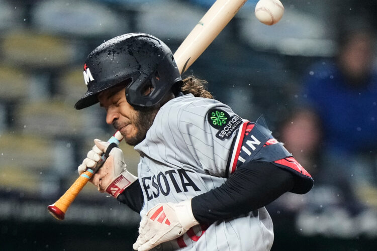 Royals outslug Twins 13-9 in rain